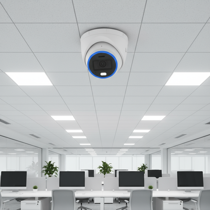 White security camera with blue accent on a white background